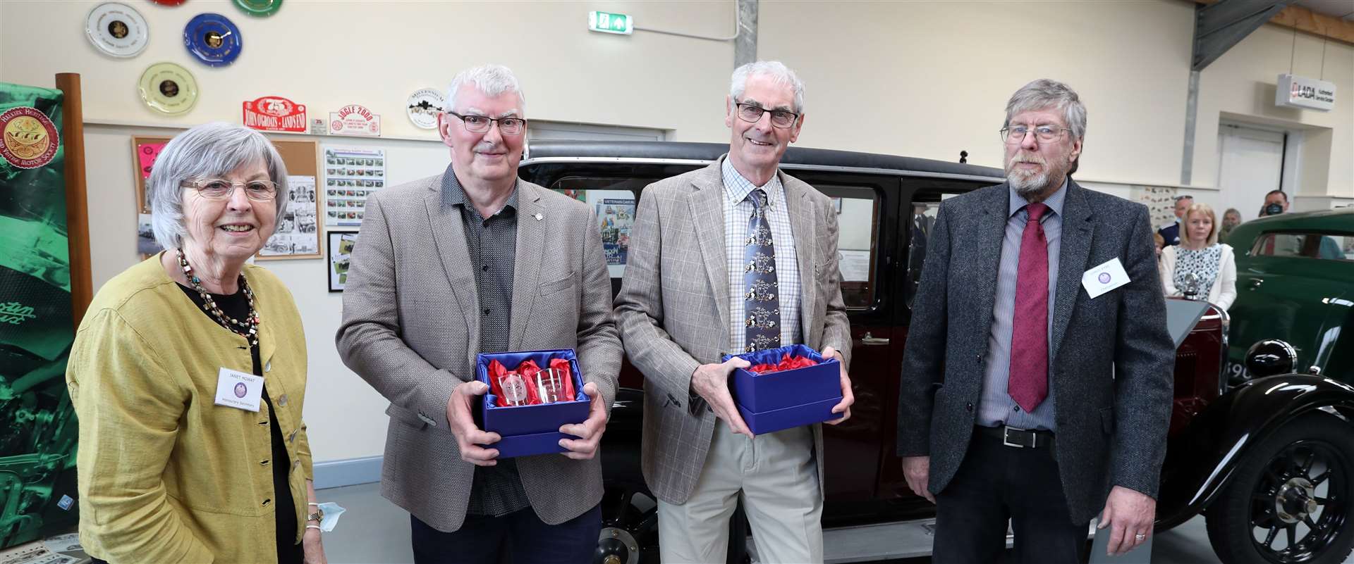 Iain and Alasdair Sutherland are presented with glass mementoes by Janet Mowat and Chris Eyre, secretary and chairman respectively of Halkirk Heritage and Vintage Motor Society. Picture: James Gunn
