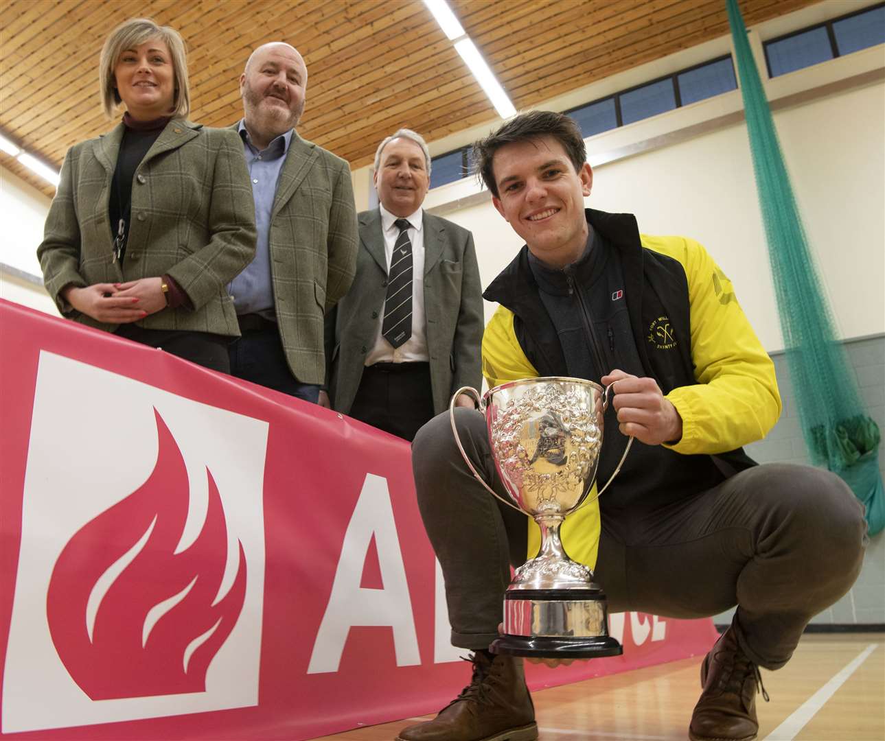 Representatives of Alvance British Aluminium, Rosie Flannigan and Tom Uppington with Camanachd Association President Keith Loades alongside Fort William Shinty Player and Alvance Engineer Arran McPhee holding the Cup. Picture Iain Ferguson. The Write Image
