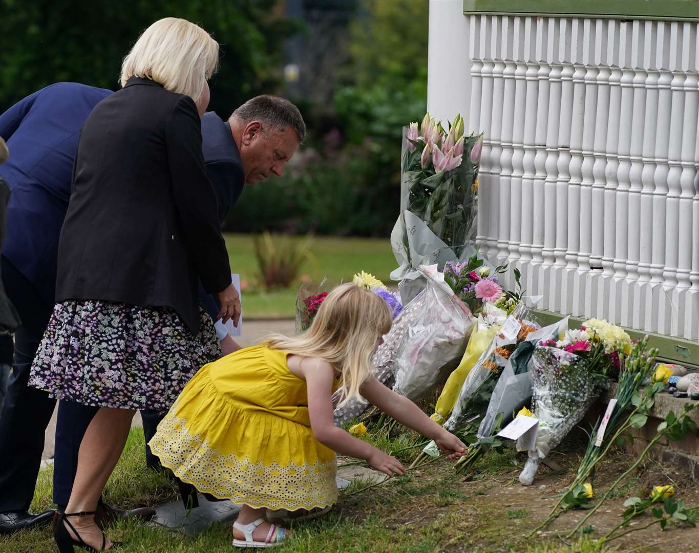 The families of the three victims lay a single yellow rose each in Reading’s Forbury Gardens to mark the one year anniversary of the attack (Steve Parsons/PA)