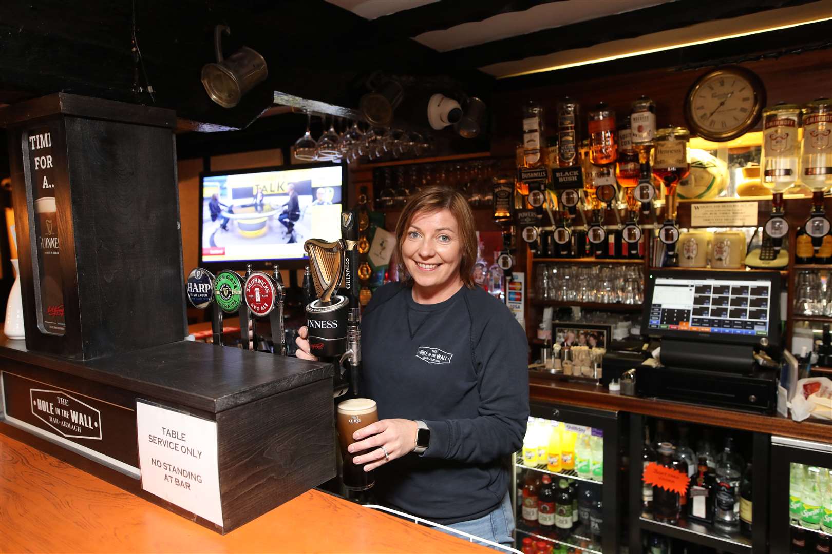 Joanne Shilliday pulls a pint in her pub The Hole In The Wall Bar in Armagh (Peter Morrison/PA)