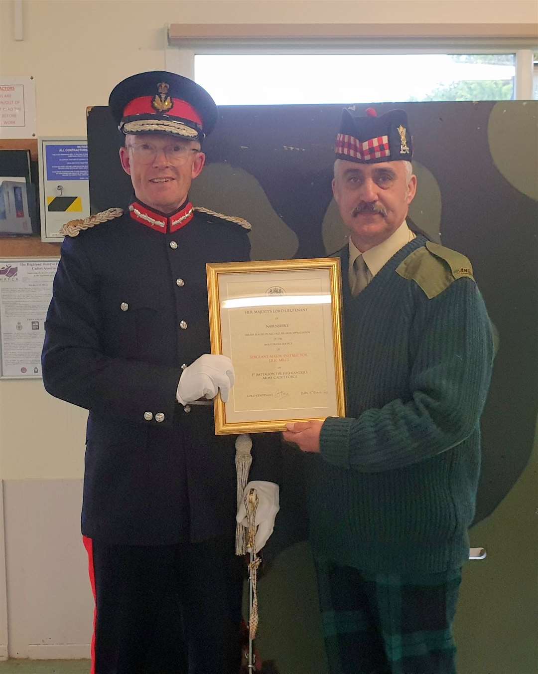 SMI Mills (right) receiving his Lord Lieutenant's Certificate from Mr George Asher, Lord Lieutenant of Nairnshire