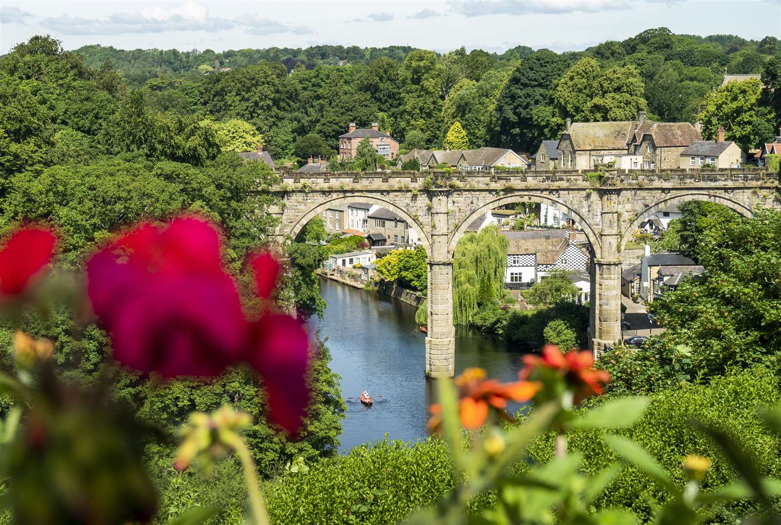 People enjoy the hot weather in a rowing boat underneath the Knaresborough Viaduct (Danny Lawson/PA)