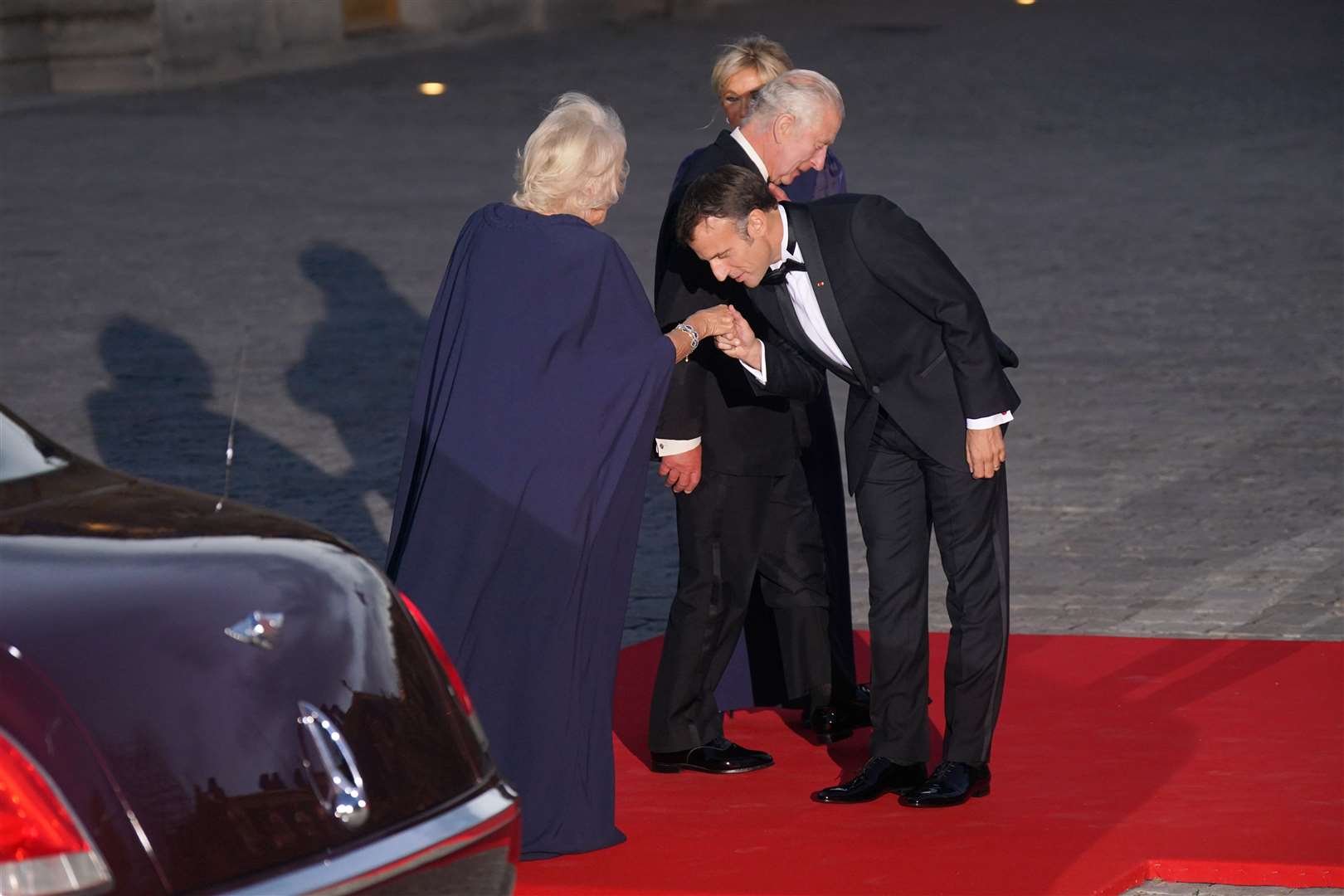 Emmanuel Macron kisses Queen Camilla’s hand as she and the King arrived for the banquet (Yui Mok/PA)