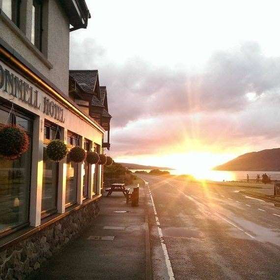 The Dundonnell Hotel beer garden is on both sides of the road with views over Little Loch Broom.