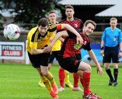 Nairn County defender Sean Webb and Inverurie Locos' Ryan Broadhurst battle for the ball with former ICT and Ross County midfielder Iain Vigurs watching on.