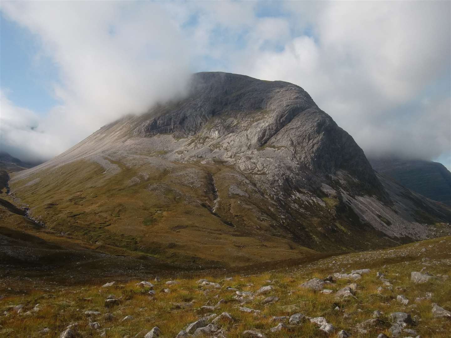 Heading over rough ground to the burn under Ruadh-stac Bheag, whose rocky northern ramparts are now clear.