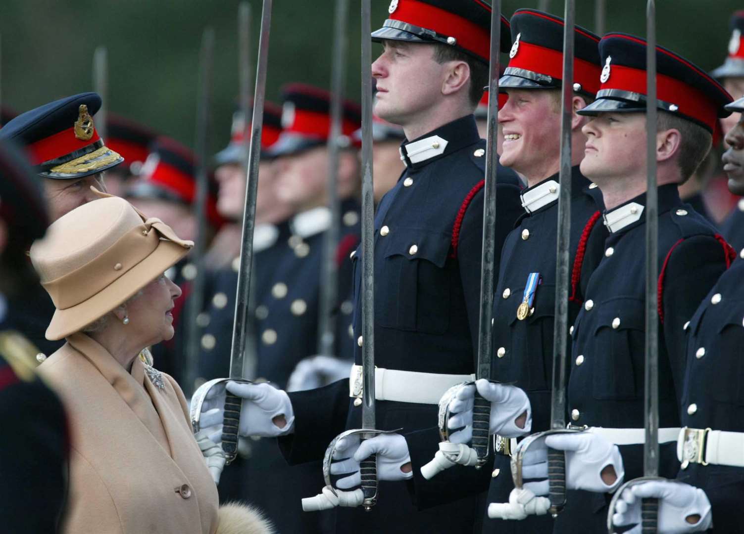 Harry smiles broadly as his grandmother the Queen reviews him and other officers during the Sovereign’s Parade at Sandhurst in 2006 (James Vellacott/PA)