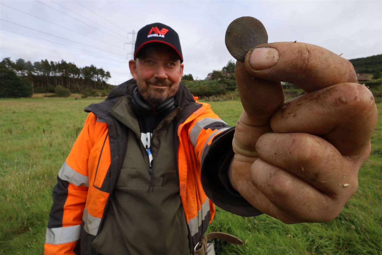 Metal detecting enthusiast Paul Briggs with a "toasted" coin.