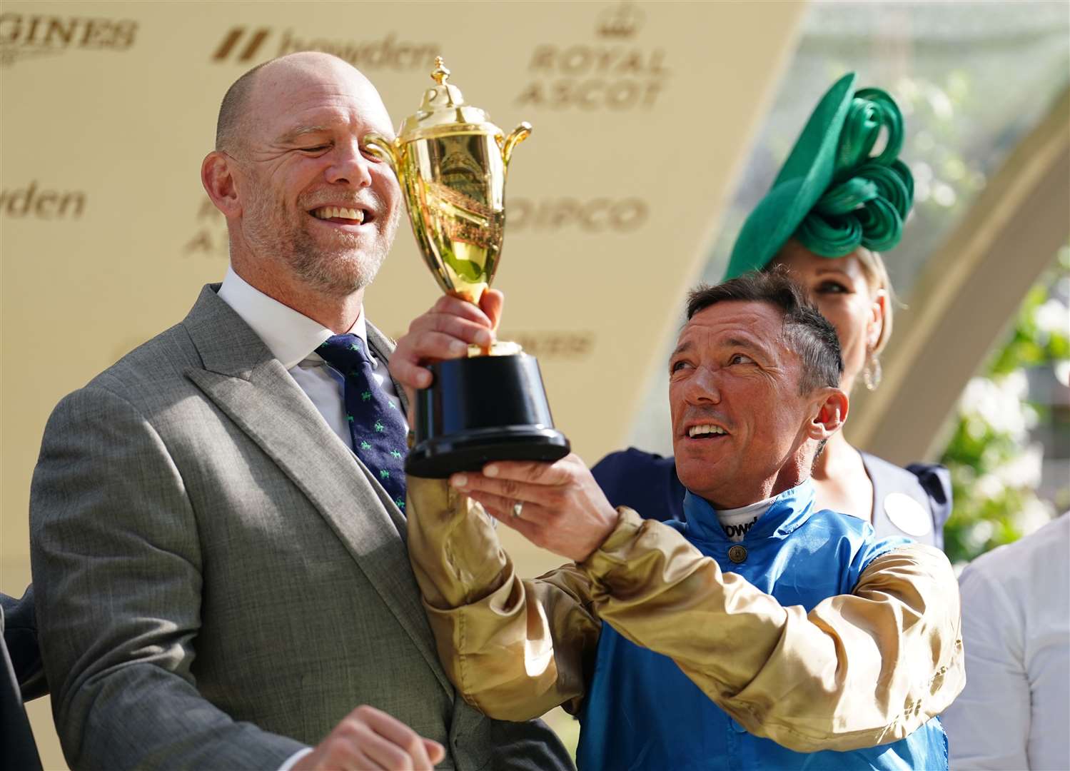 Frankie Dettori celebrates after being presented with a trophy by Mike Tindall and Zara Tindall after winning the Queen’s Vase on Gregory (David Davies/PA)