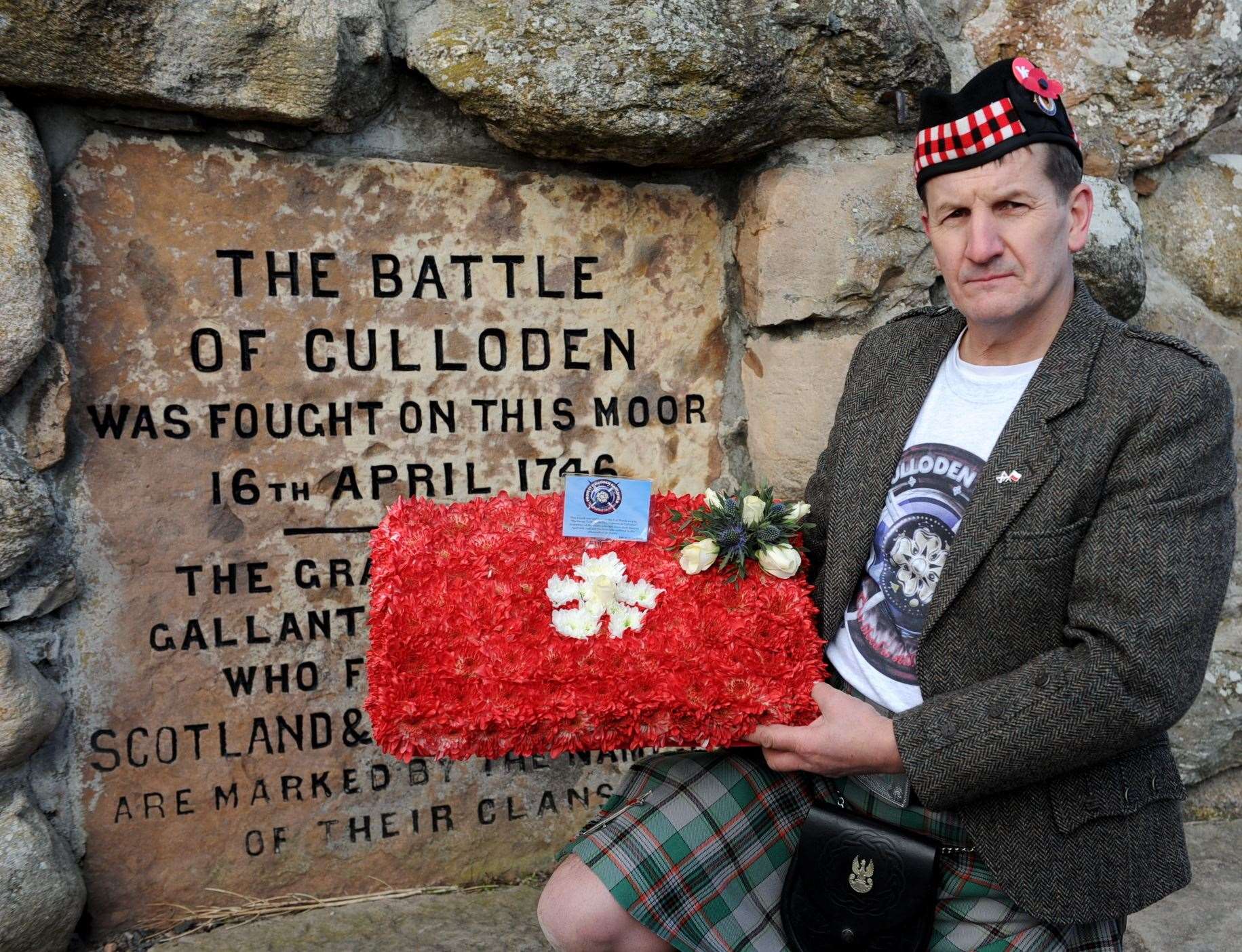 Protest march at Culloden Battlefield against the development by Inverness Properties , with organiser George Kempik laying a wreath for the Fallen . . Picture: Gary Anthony. Image No.024861.