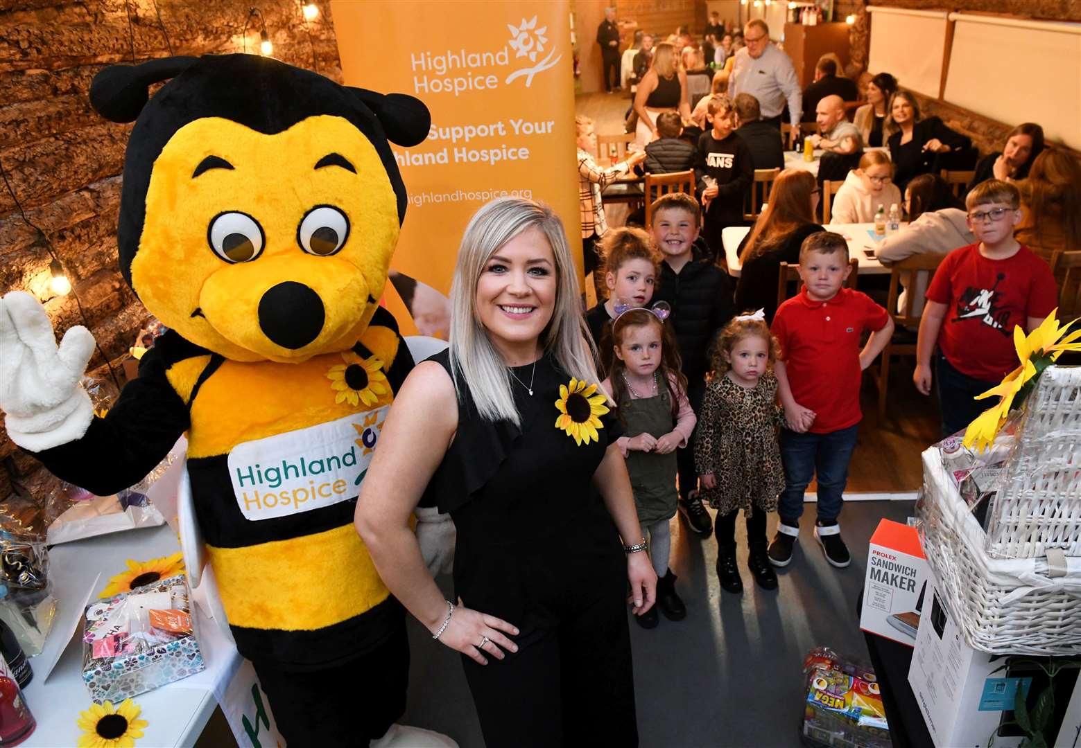 Donna Carolyn Fraser with Bobby the Bee in front of all the people who came along for the bingo. Picture: James Mackenzie.