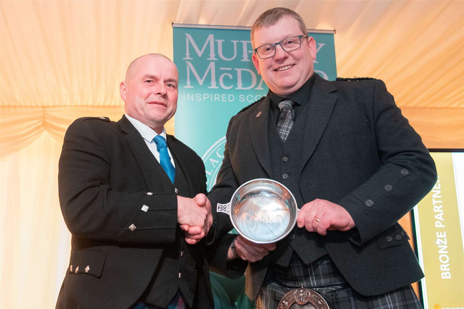 Billy Wright (left) presents Keith Brian with the Unsung Hero award. Picture: Daniel Forsyth