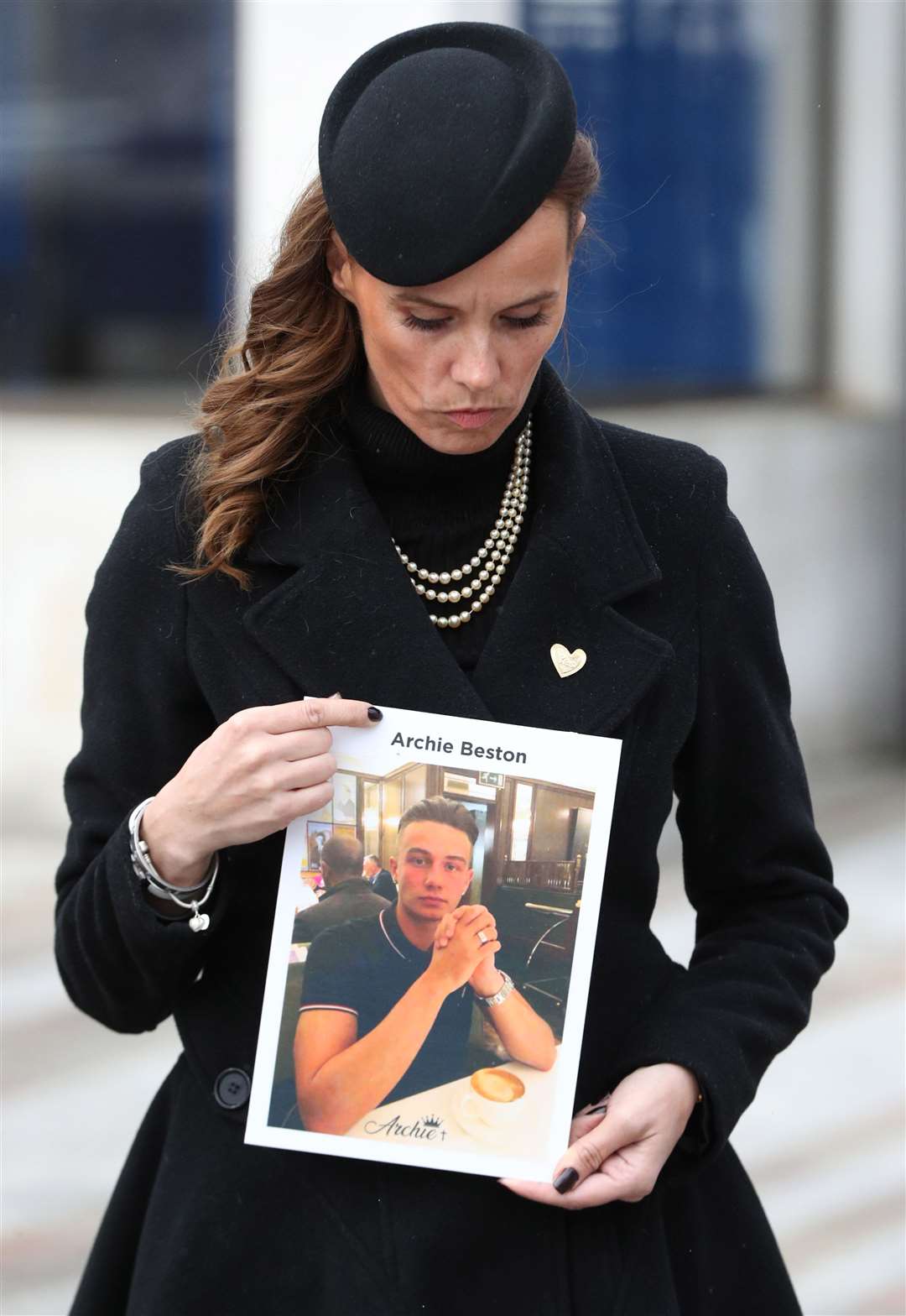 Becky Beston holds a photo of her son Archie who was fatally stabbed in Kingston in February last year (Jonathan Brady/PA)