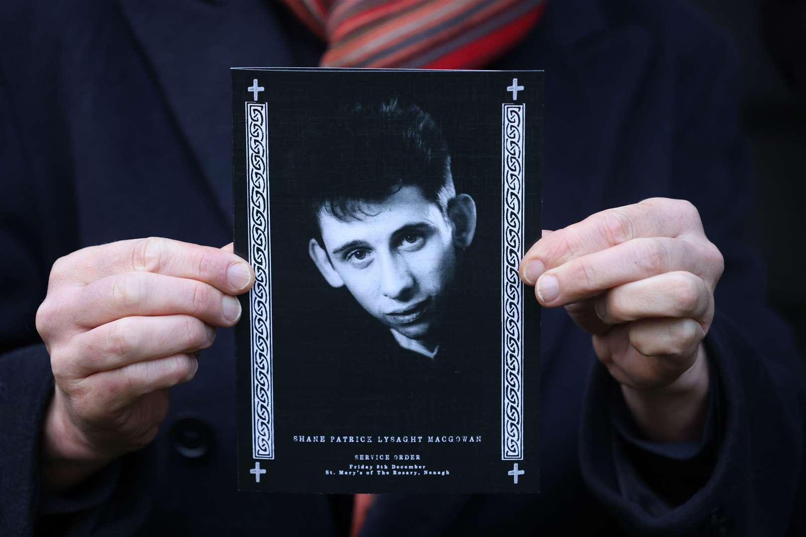 A mourner holds the order of service for the funeral of Shane MacGowan at Saint Mary’s of the Rosary Church, Nenagh (Damien Eagers/PA)