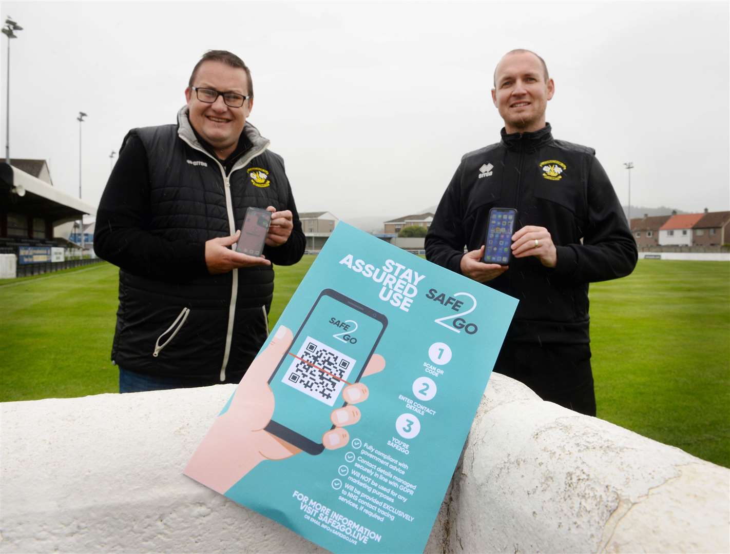 Directors Chris Forbes and Scott Dowling with the Clachnacuddin track and trace app for fans and players.