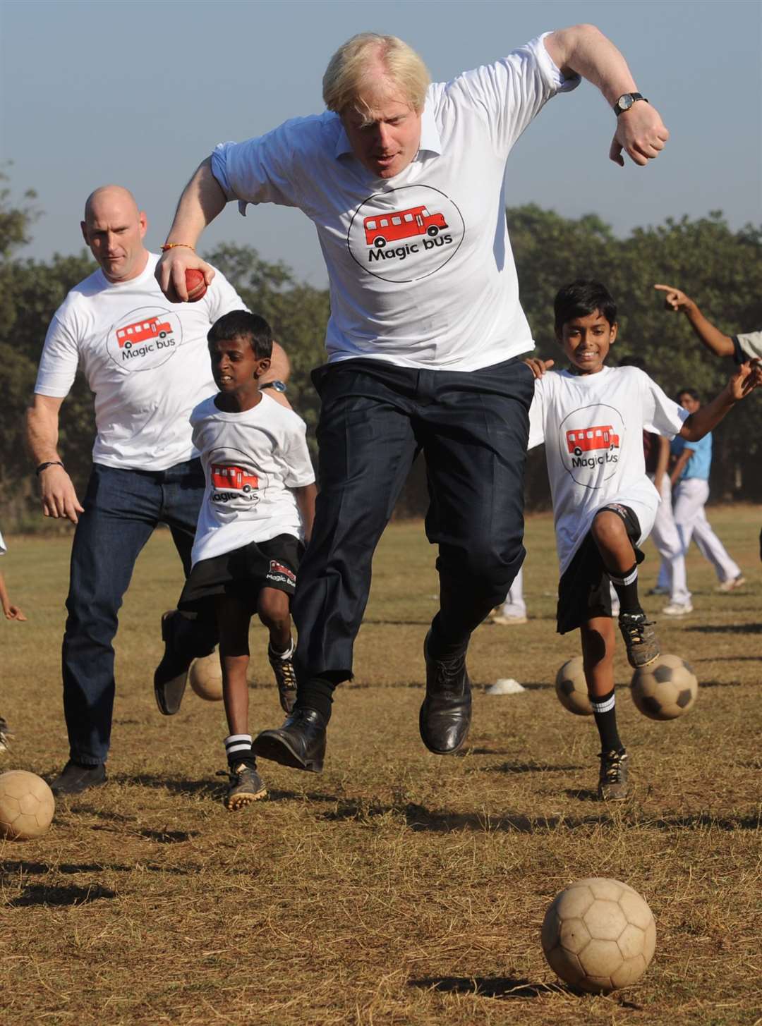 A spirited moment during the ‘ball game’ with former rugby player Lawrence Dellaglio and local children involved in the Magic Bus Project during a visit to in Mumbai in 2012 (Stefan Rousseau/PA)