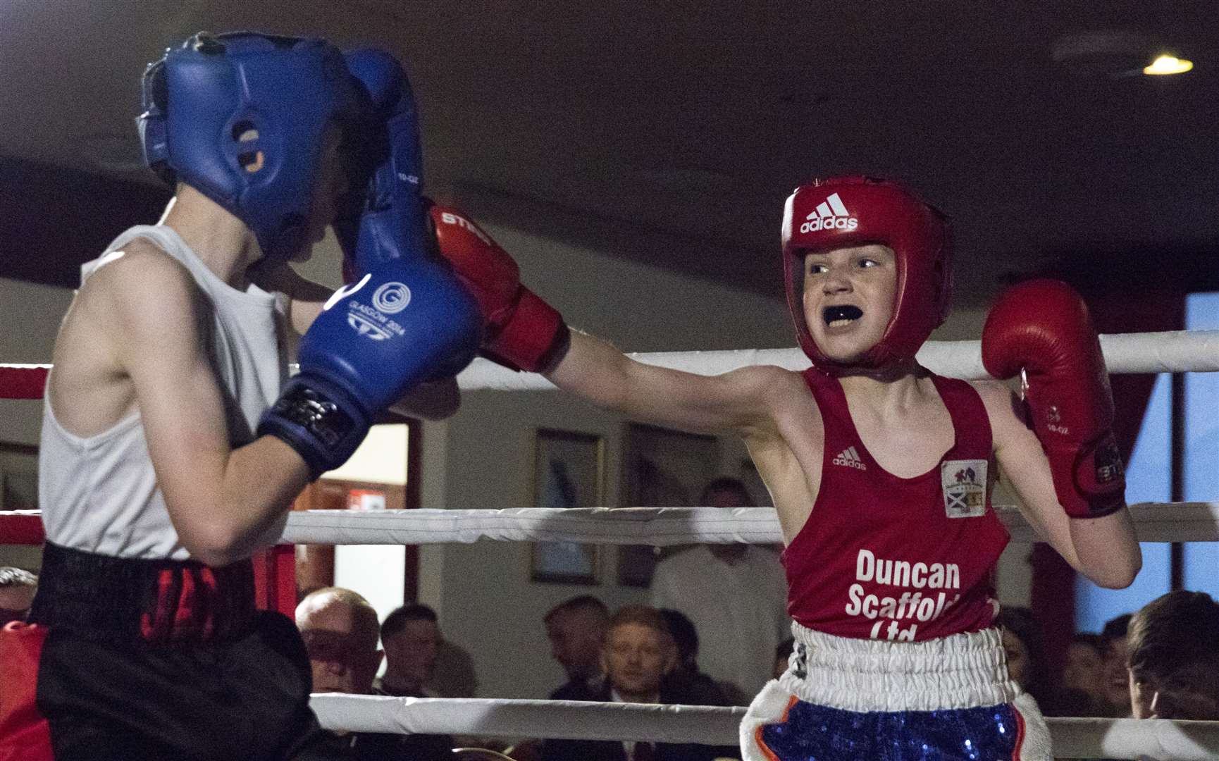 Ruari Urquhart (red) opened Highland Boxing Academy's home show in style, beating James Cook by unanimous decision. Picture: David Rothnie