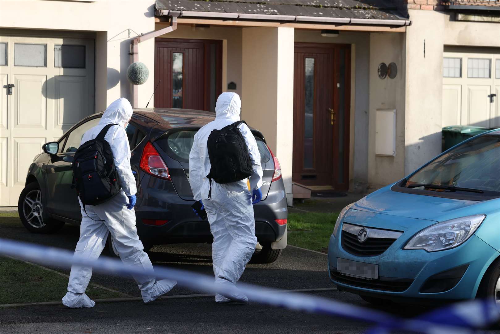 Forensic officers walk into a property in the Silverwood Green area of Lurgan (Liam McBurney/PA)