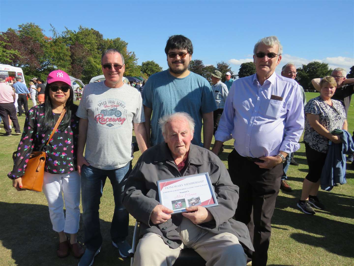 Alex Mann receives honorary membership of Fortrose and Rosemarkie Classic Vehicle Rally Committee. Behind Alex are family members L to R, Noy Mann, Gordon Mann, Jacque Mann and James Mann.