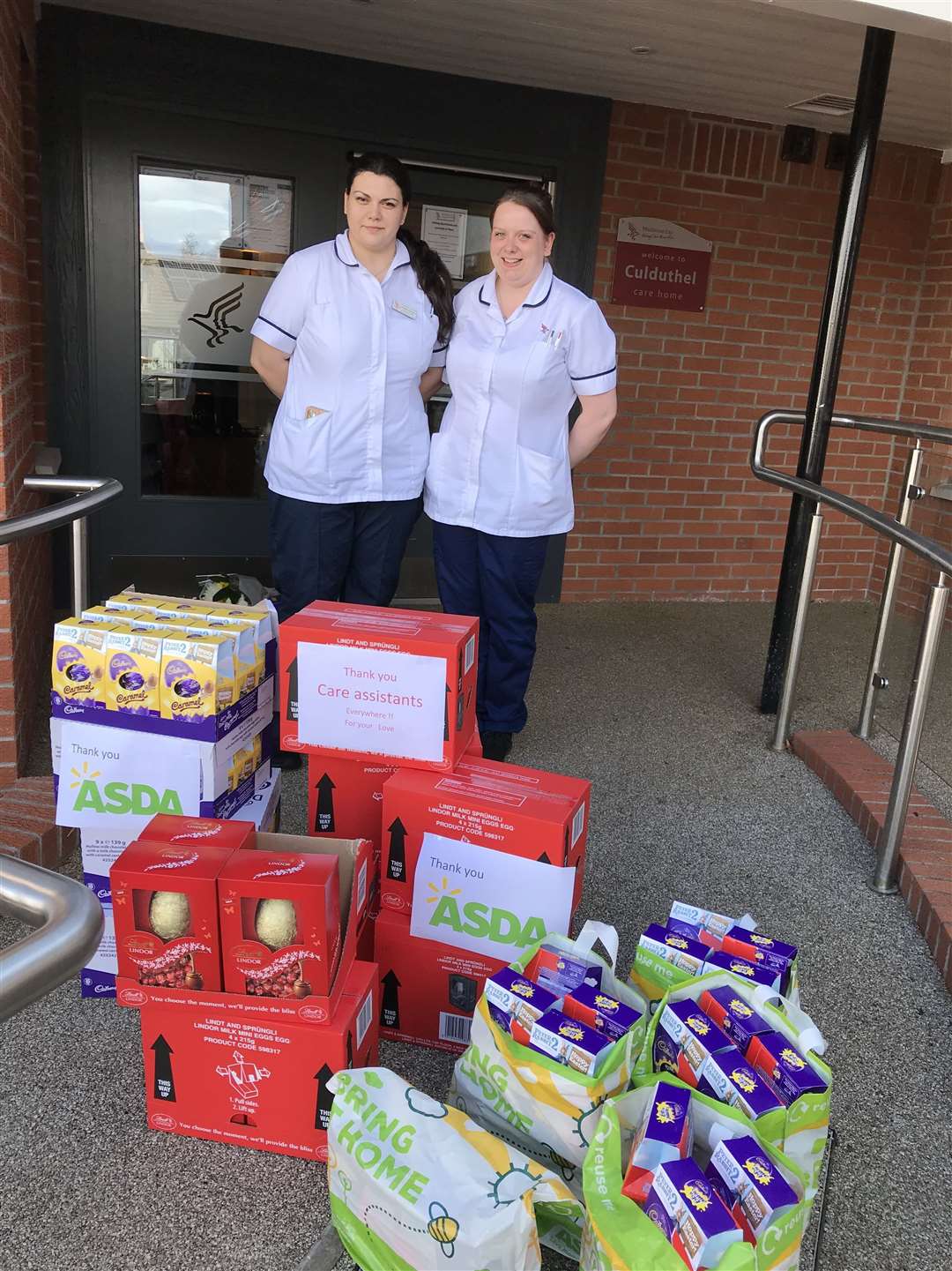 Care home employees Andrada Asoltanei (left) and Rachel Douglas with the choccy eggs for residents and staff.
