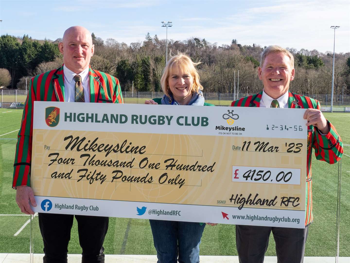 Graham Findlater (Highland RFC), Emily Stokes (CEO Mikesyline), and Roy Dinnes (President Highland RFC) with the cheque for Mikeysline.