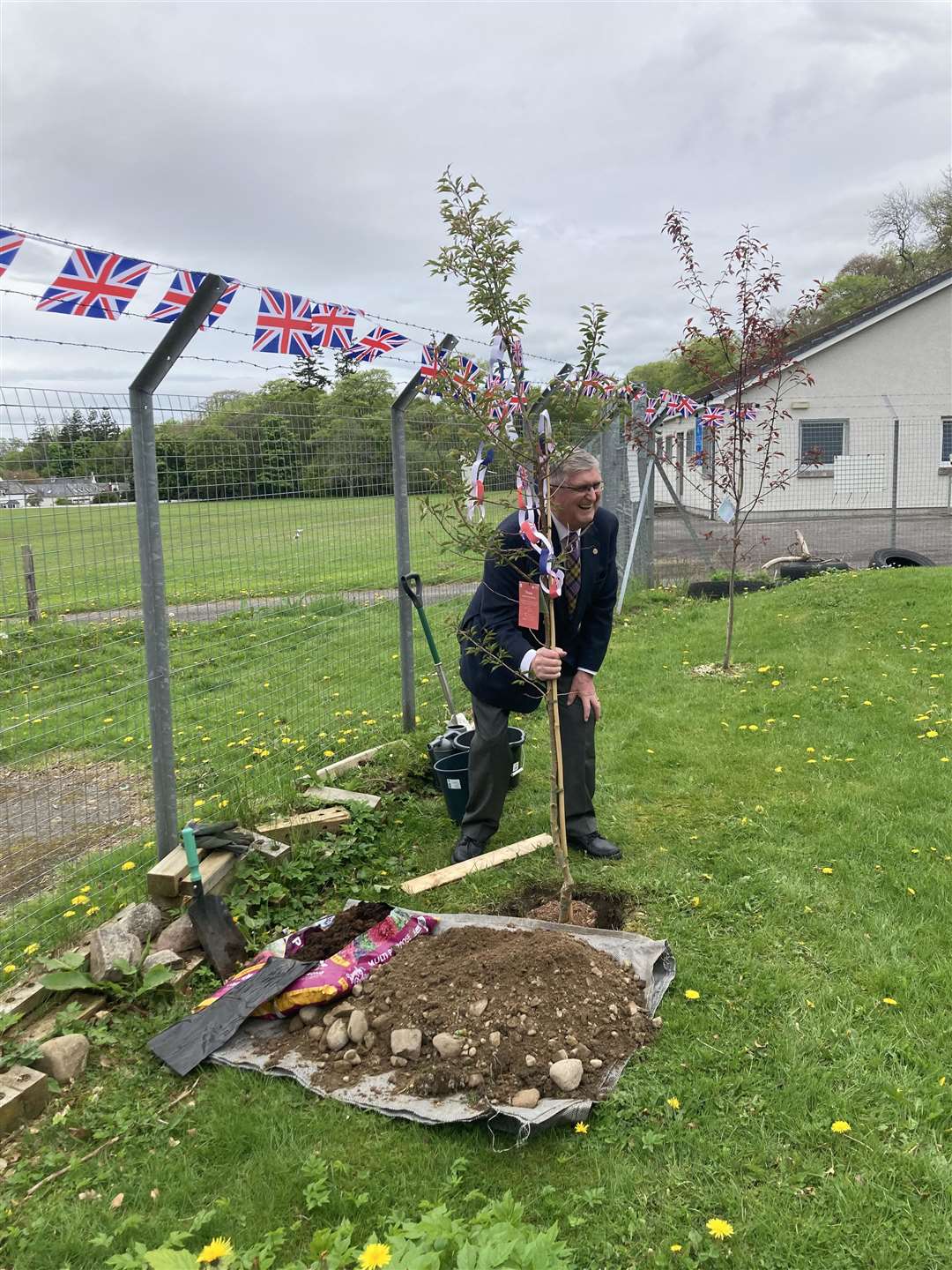 Don Williams plants an autumn flowering cherry tree in the grounds of the Smithton Culloden Youth Centre.