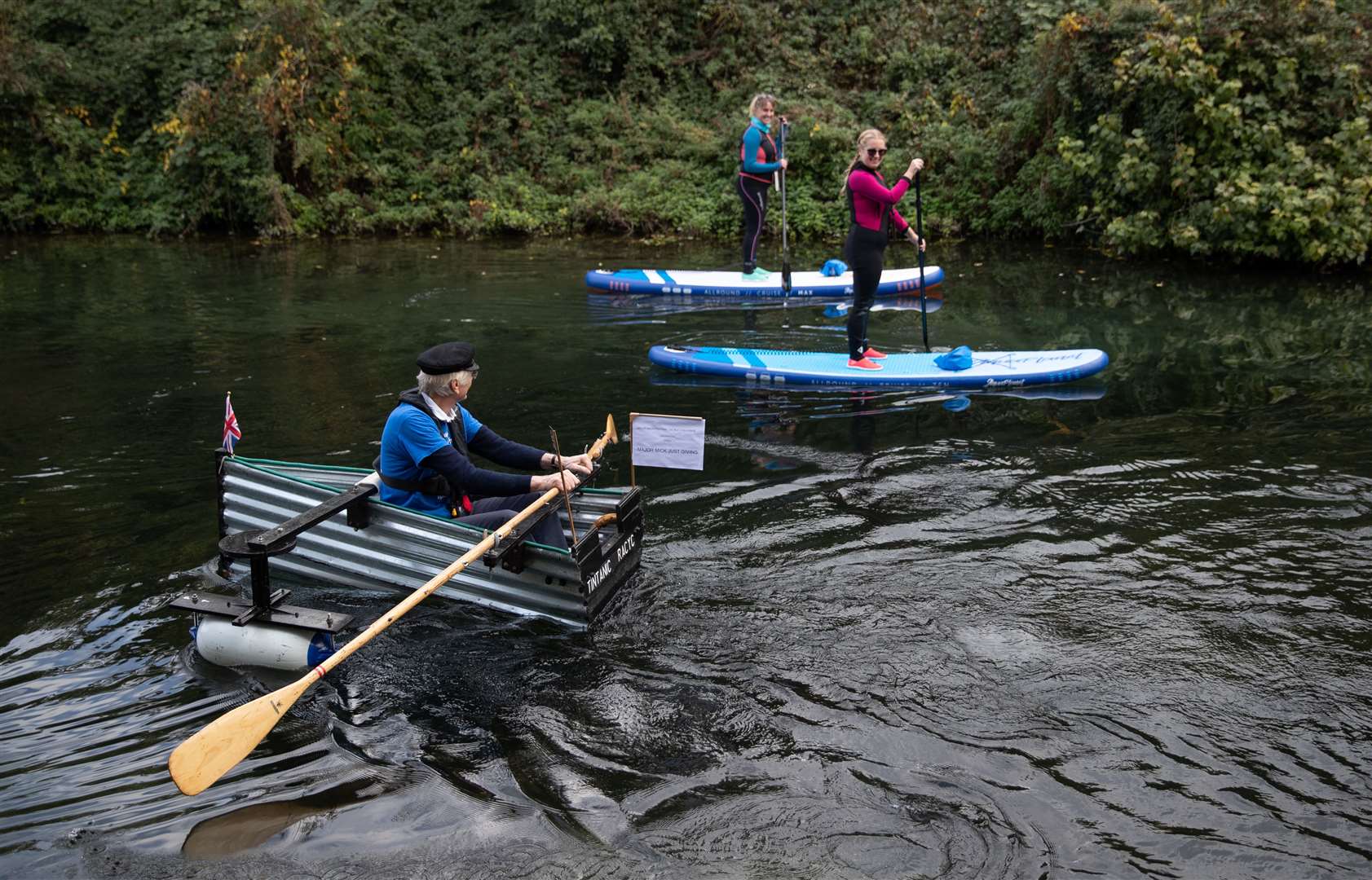 Michael Stanley rows along the Chichester canal in his home-made rowing boat (Andrew Matthews/PA)