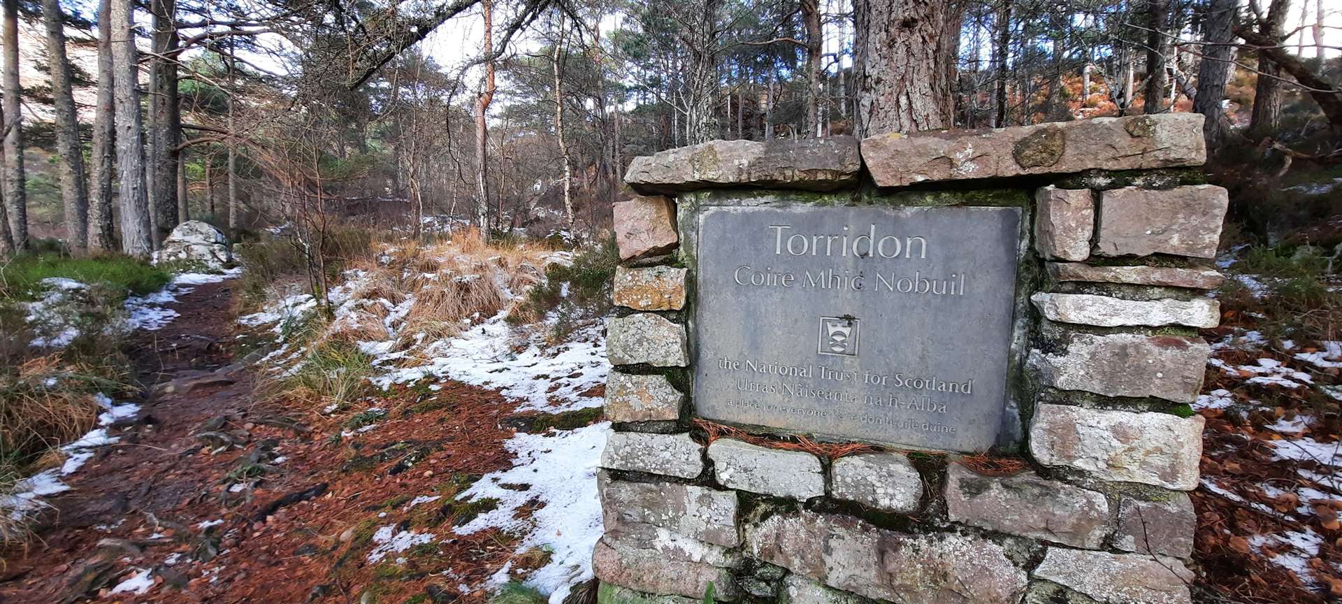 A National Trust for Scotland marker at the start of the path.