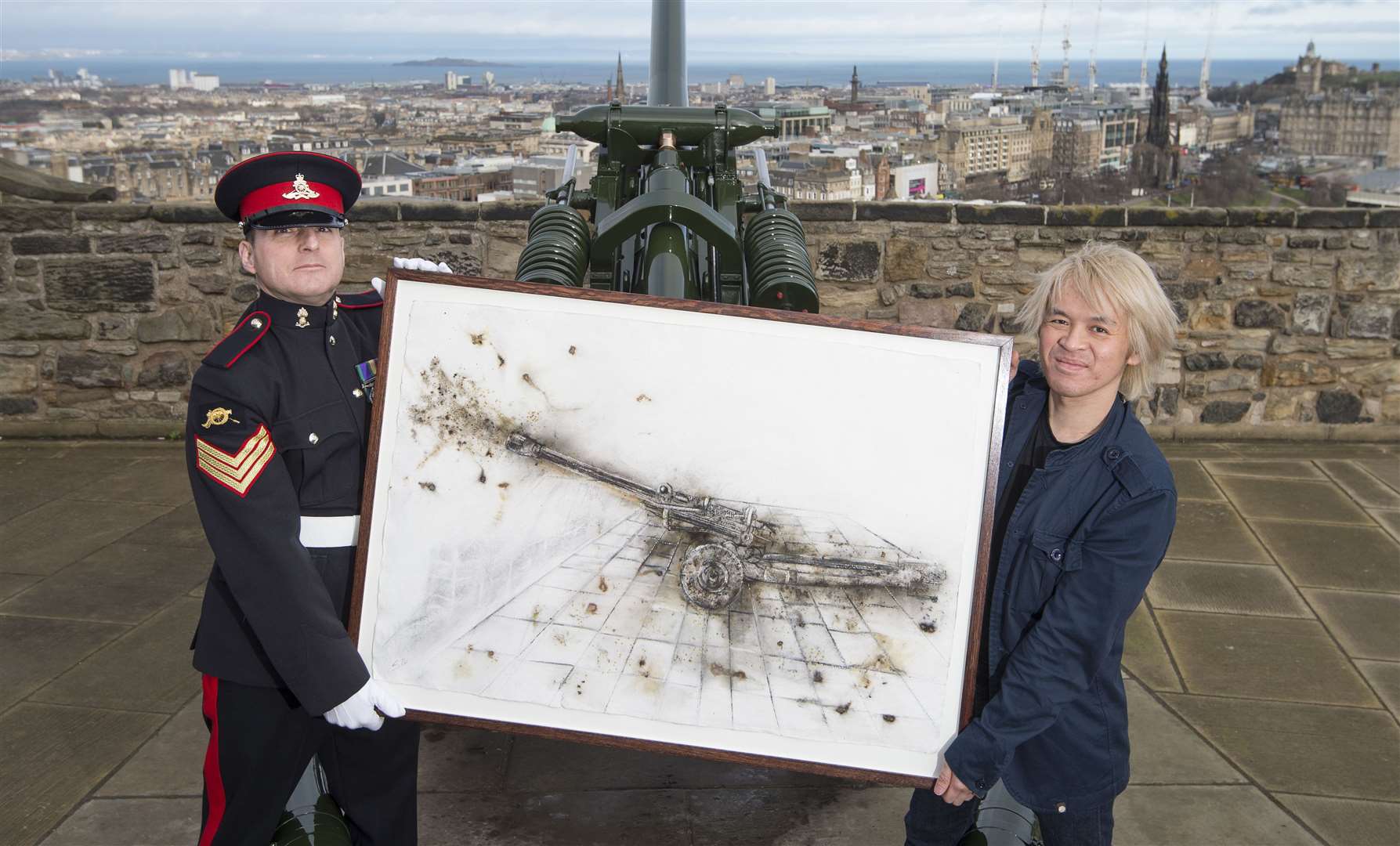 Frank To (right) presents District Gunner Sergeant David Beveridge with his artwork. Pic: Neil Hanna Photography