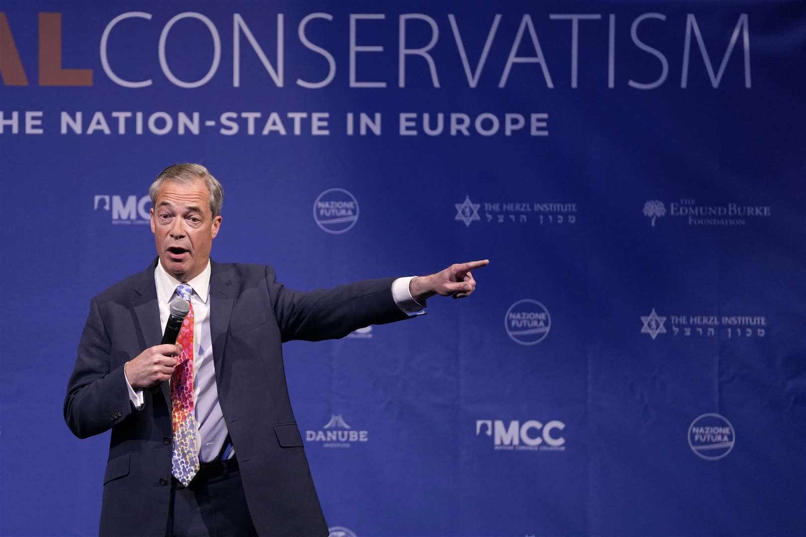 Nigel Farage speaks during the National Conservatism conference in Brussels (Virginia Mayo/AP)