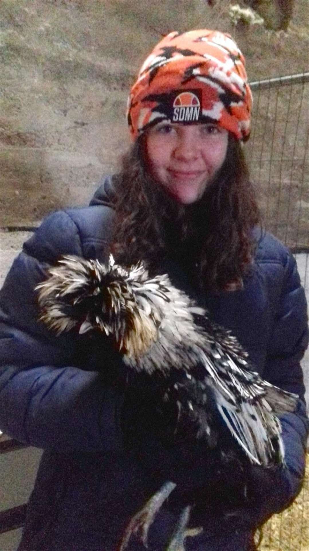 Kayleigh is pictured with some of the hens she cares for.