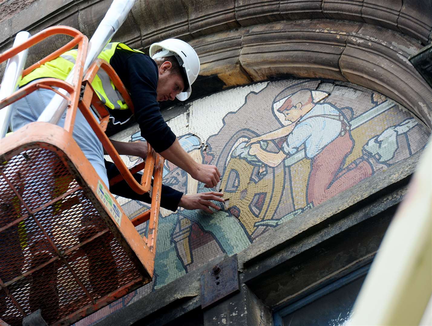 Restoration gets under way on a mosaic at the former AI Welders building in Academy Street. Picture: Gary Anthony.