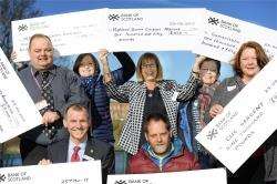 Pictured are some of the cheque recipients (from left) - Andrew Leaver of Highland Hospice and Lee Gordon of Headway Highland; rear - Gordon Bogan of the Scottish Huntingtons Association, Beth Anderson of the MS Centre, Bet McAllister for the Senior Citiz