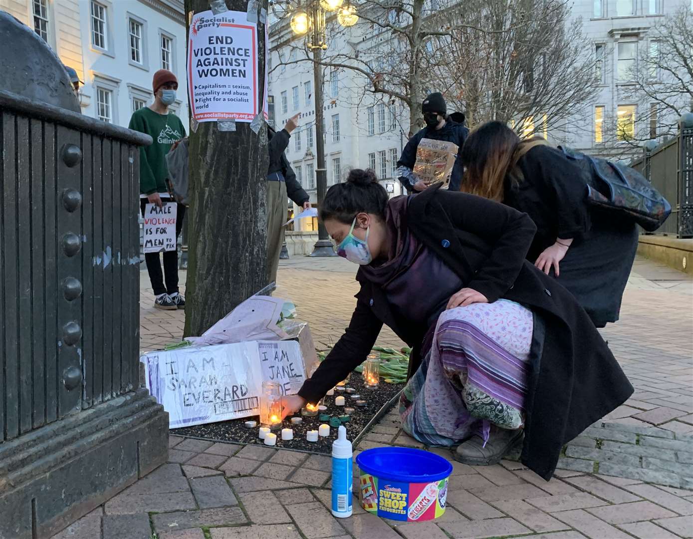 A woman places a candle in Birmingham after the Reclaim These Streets vigil for Sarah Everard was officially cancelled (Richard Vernalls/PA)