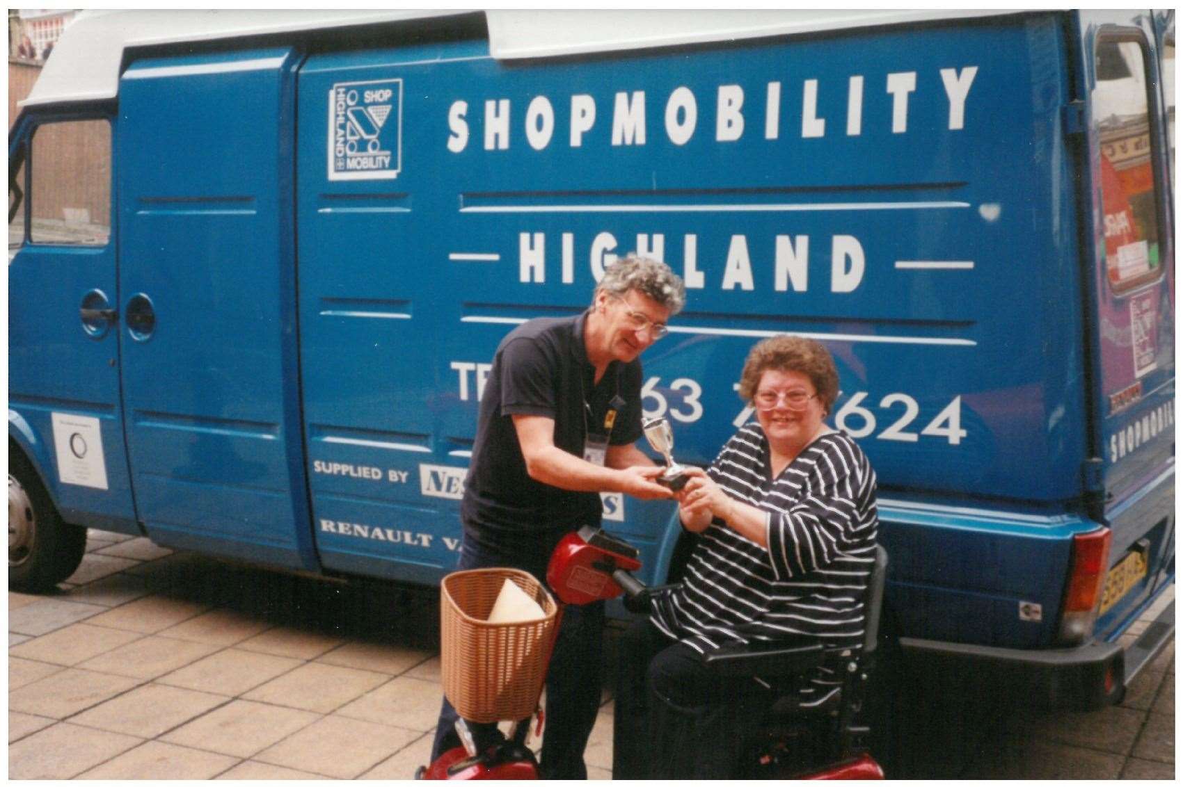 Former manager Ken MacKay with Shopmobility Highland's 2000th member Ann O'Brien in 1998.