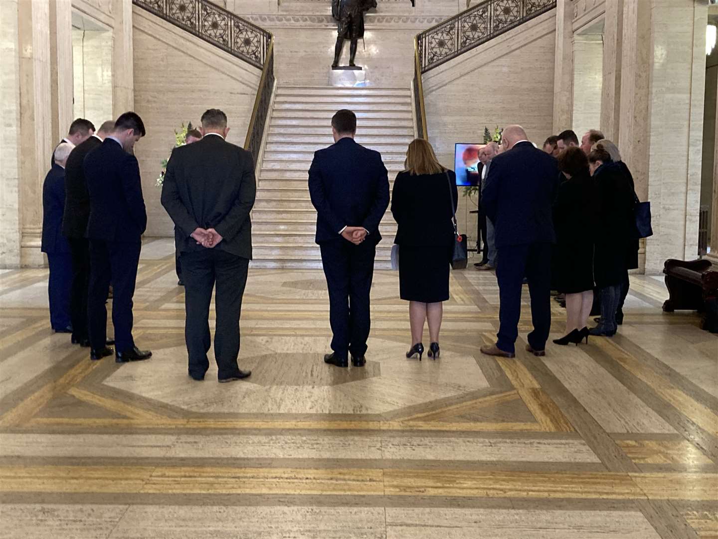 DUP MLAs pause for a prayer in the Great Hall at Stormont following the sudden death of Christopher Stalford (Rebecca Black/PA)
