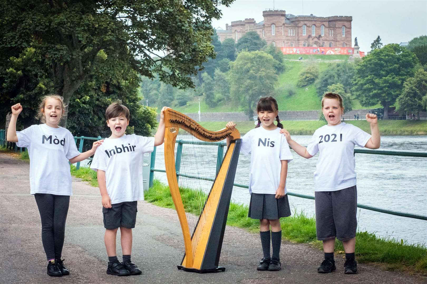 Children from Inverness Gaelic School, from left, Ava Williams (9), Ruaraidh MacLeod (6), Isobel Simpson (8) and Hunter Williams (8) celebrating the launch of Mòd 2021 on the banks of the River Ness.