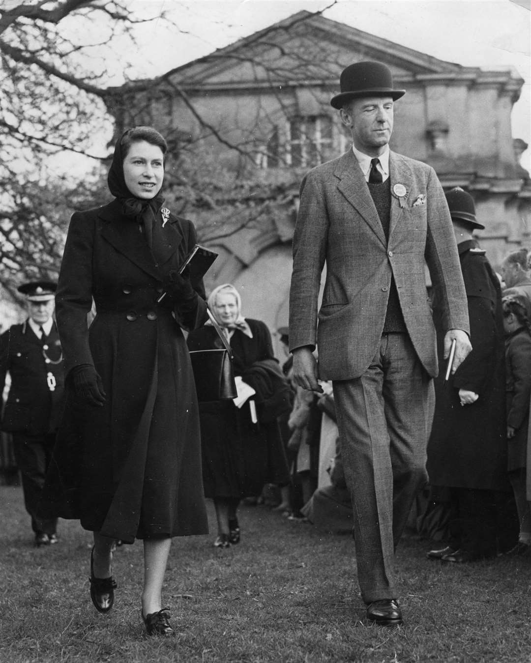 The young Queen walks with the Duke of Beaufort at the Olympic Horse Trials at Badminton in April 1952 (PA)