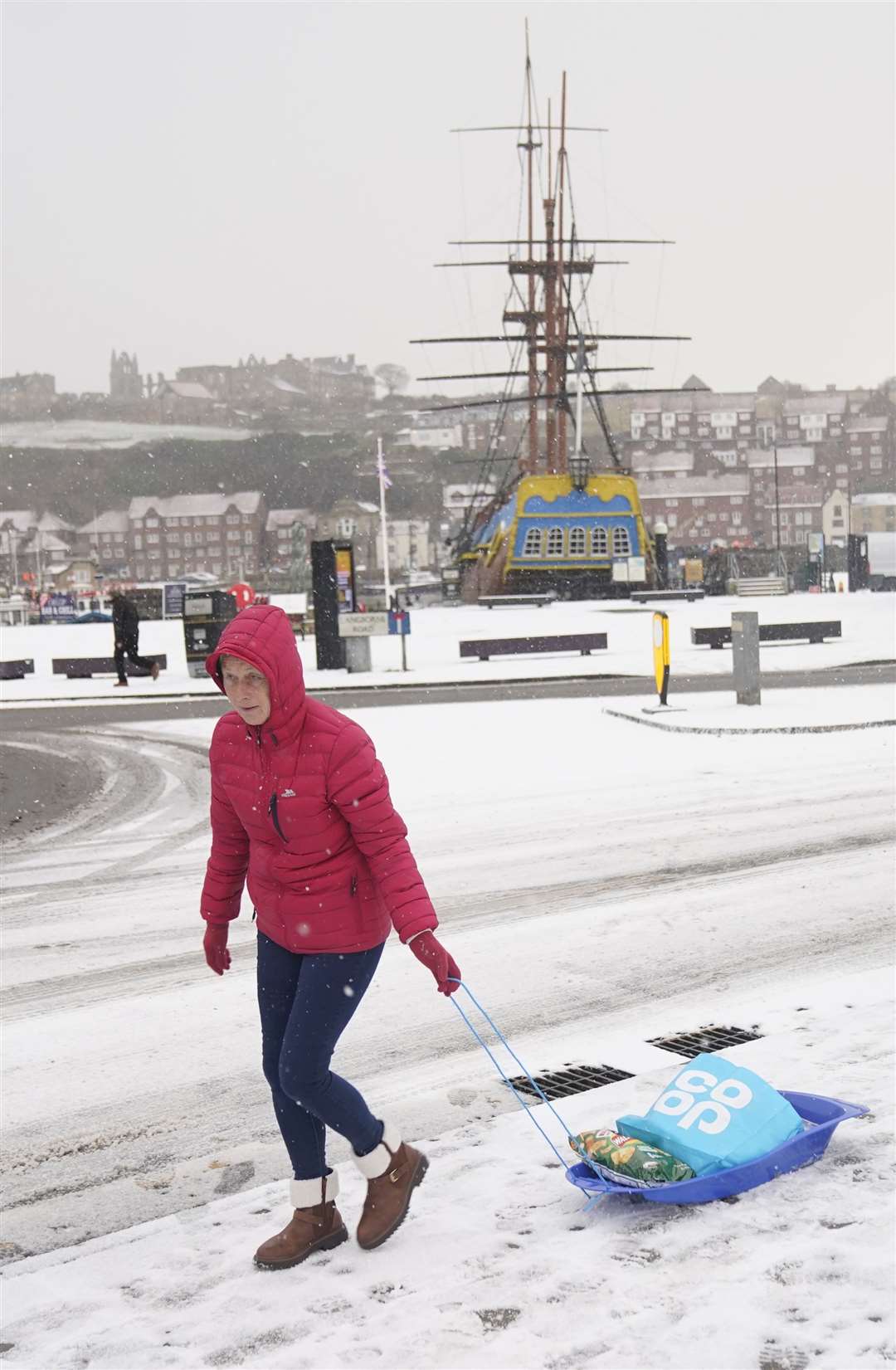 Shopping with a sledge in Whitby, North Yorkshire (Danny Lawson/PA)