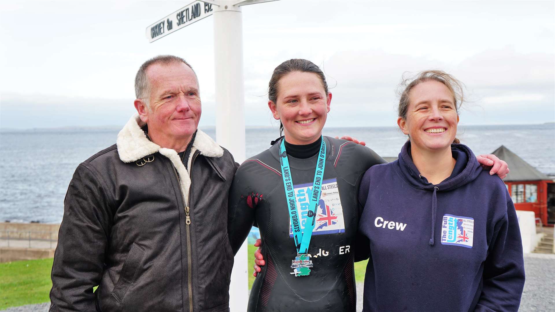 Jasmine flanked by her parents Susan and Keith after the record breaking swim. Picture: DGS
