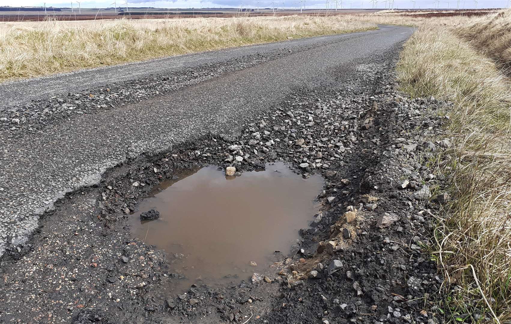 A pothole on a minor road in Caithness with wind turbines in the distance (picture taken earlier this month).