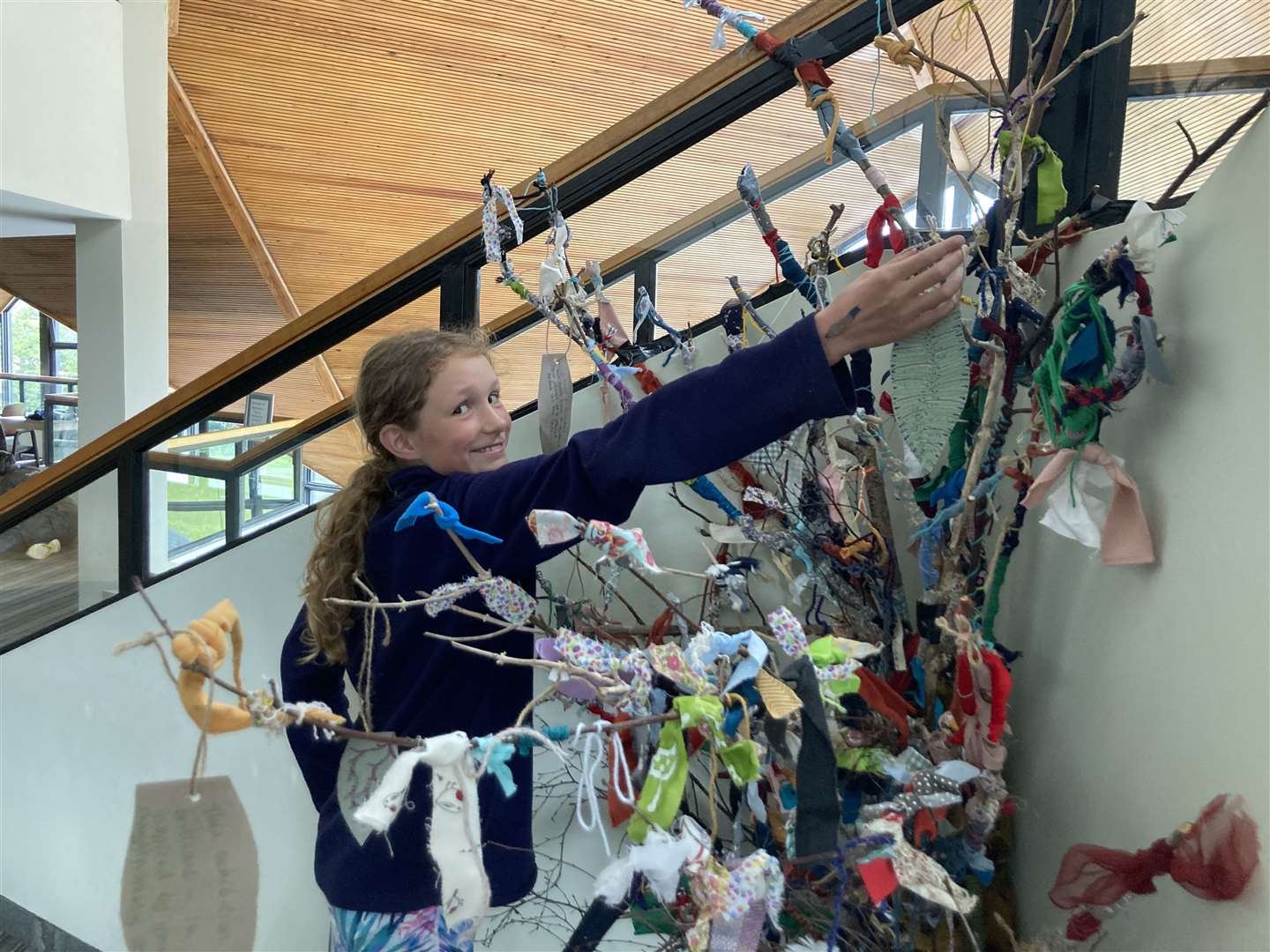 Annie Elnglish adding notes of hope to the tree at Eden Court. Picture by: Trees for Life.