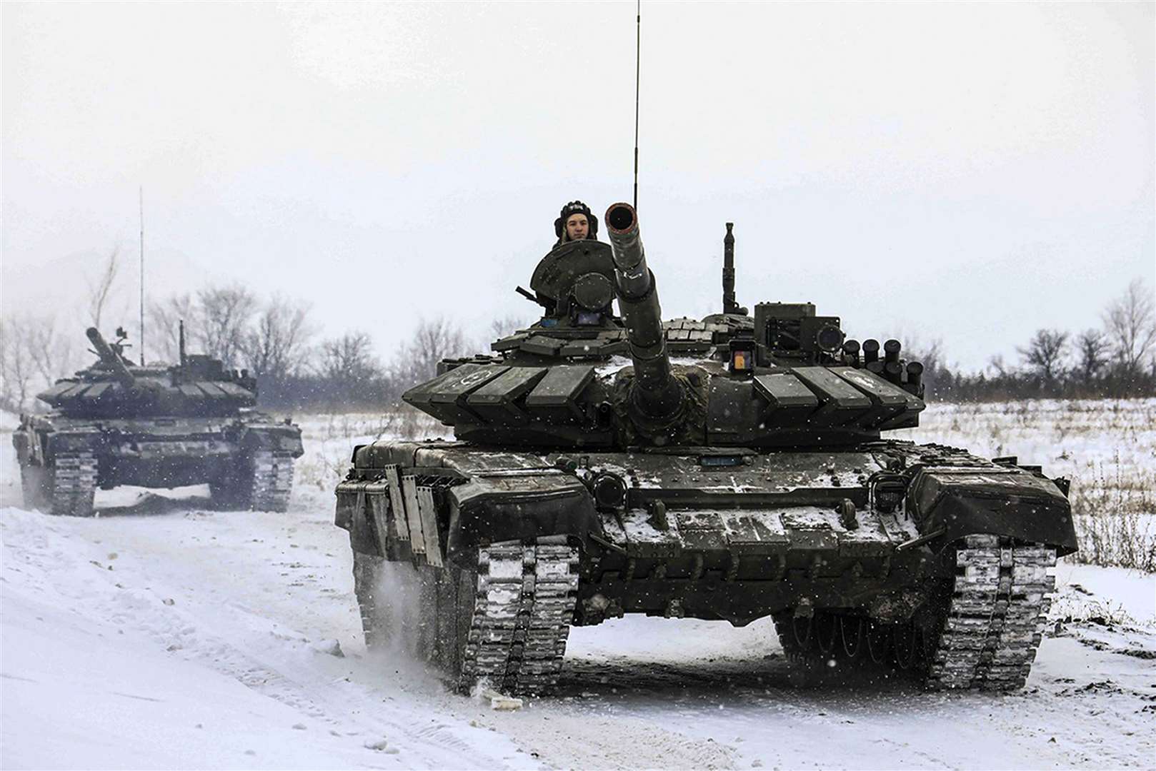 Russian tanks roll on the field during a military drills in Leningrad (Russian Defence Ministry Press Service via AP)