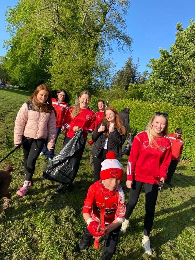 Youngsters help keep their area clean.