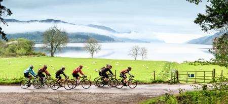 Cyclists passing the south side of Loch Ness beyond Fort Augustus before the big climb up Glendoe.