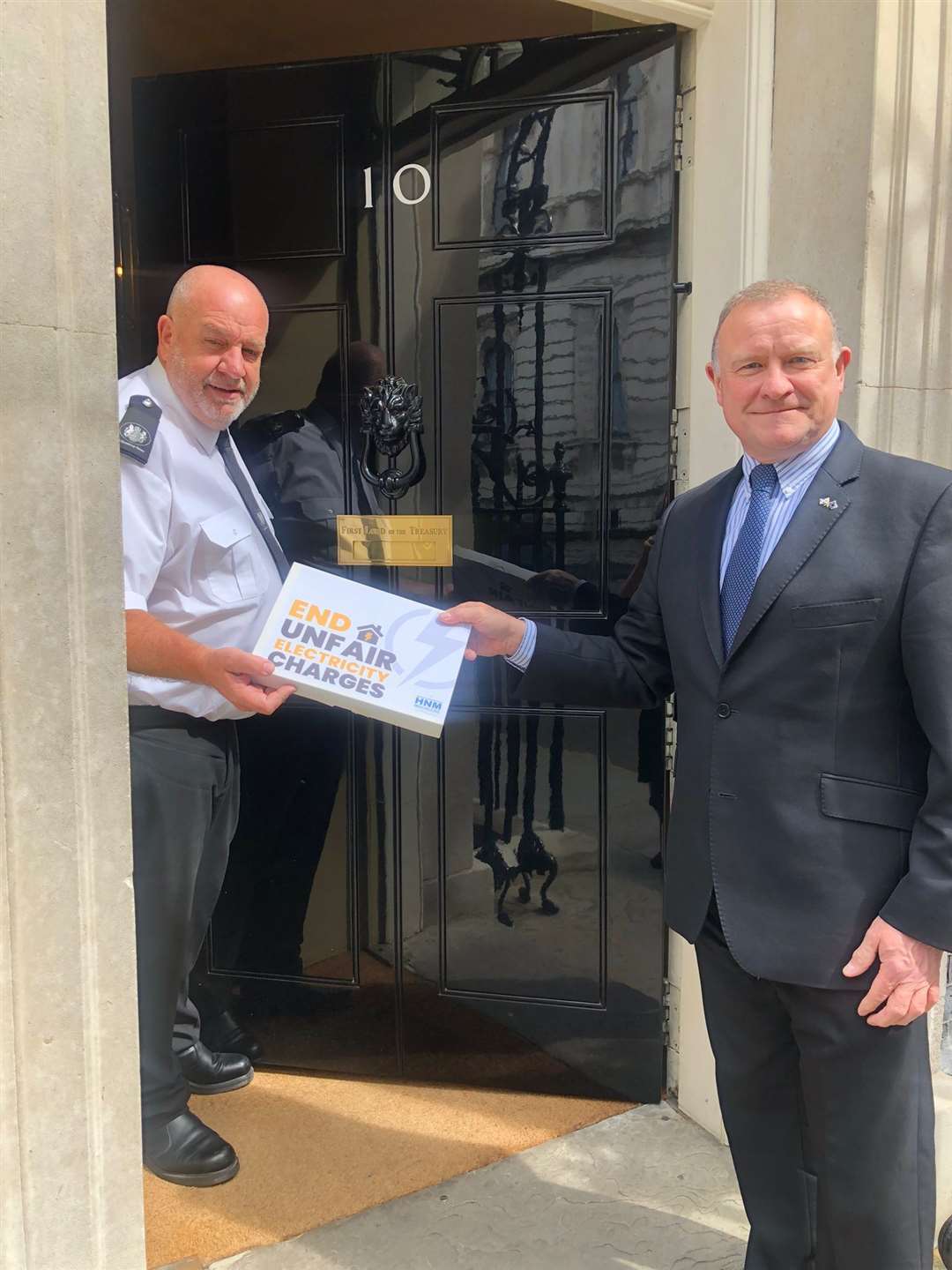 Inverness MP Drew Hendry delivers the Courier's petition calling for an end to higher electrity charges to 10 Downing Street.