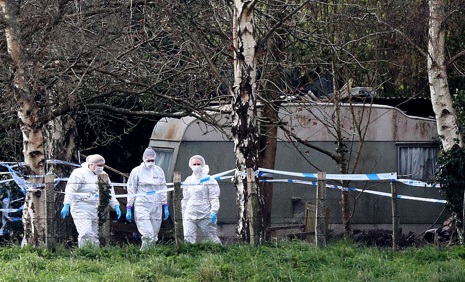 Forensic officers at the scene in Duffield Lane, Woodmancote, West Sussex, where a family of four and their dog were found dead (Andrew Matthews/PA)