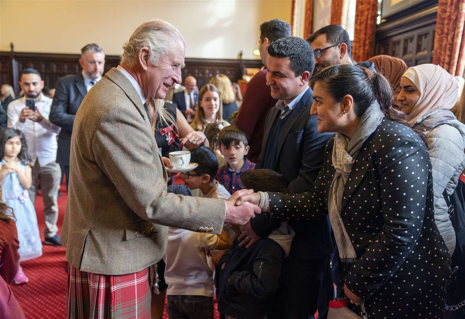 The King met Burhan Vesal, his wife Narcis and son, Sapehr, who fled Afghanistan (Jane Barlow/PA)