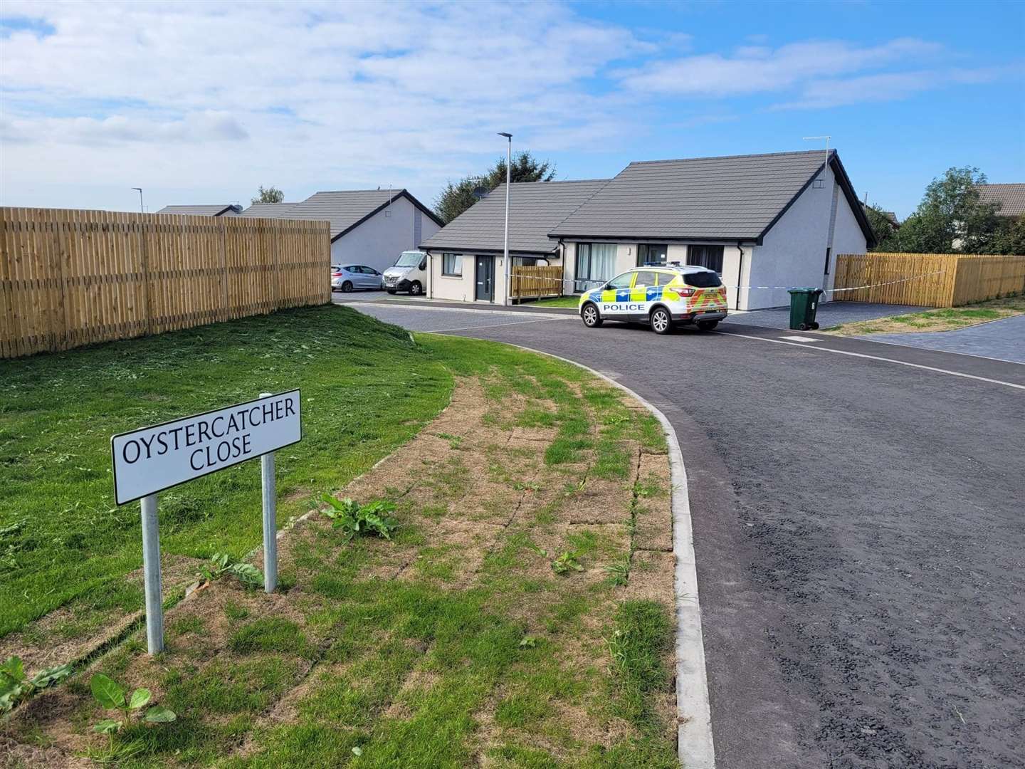 Police guard the scene outside the woman's home in Forres. Picture: Highland News and Media