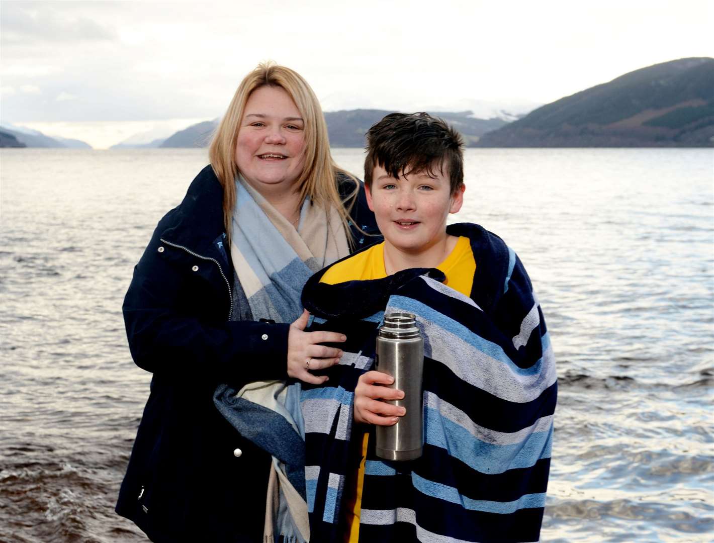 Ronnie Malcolm (11) getting warm again with mum Jackie after his fundraising dip at Dores. Picture: James Mackenzie